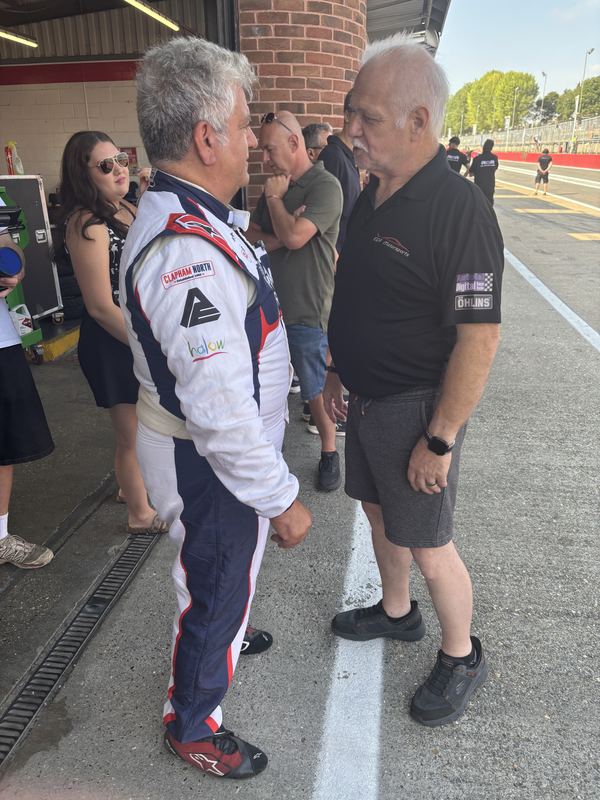 George Grant talking with a team member in the pit lane