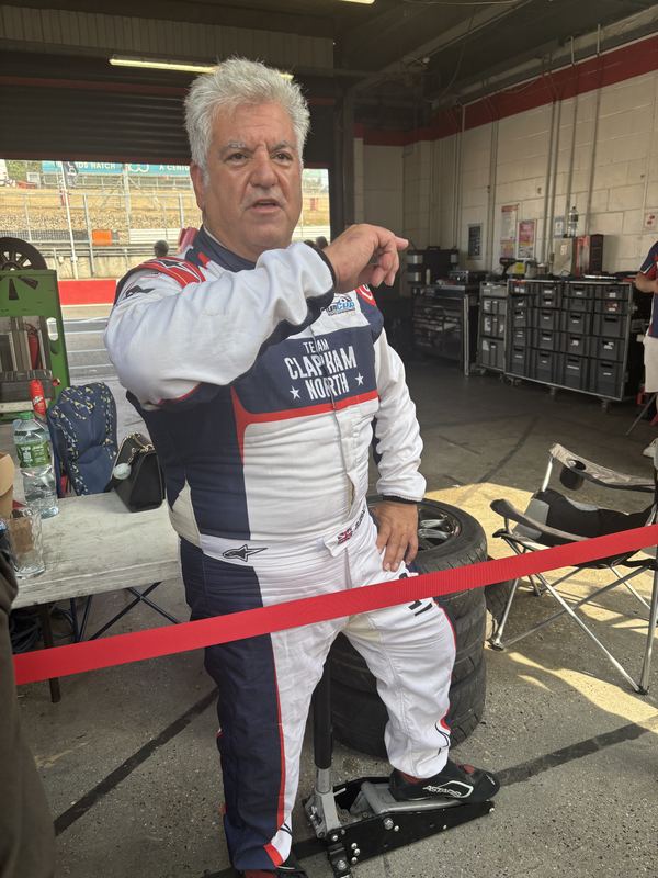 George Grant in his race suit in the pit garage