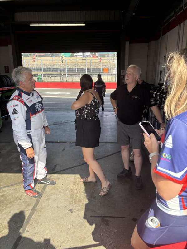 George Grant greeting guests inside the pit garage