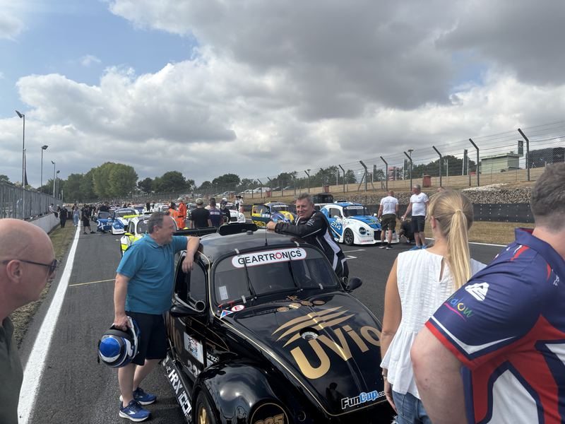 Guests beside a Fun Cup car on the grid