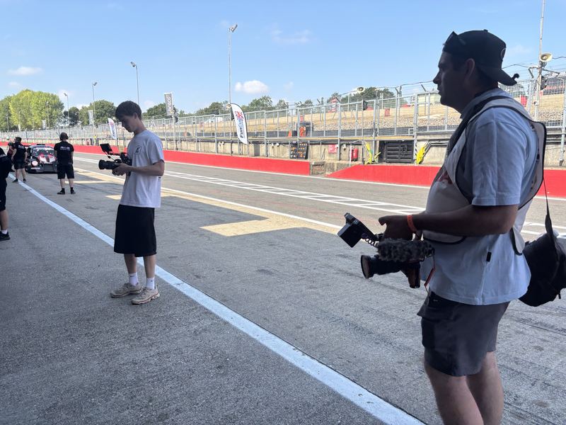 A camera operator filming in the pit lane at Brands Hatch