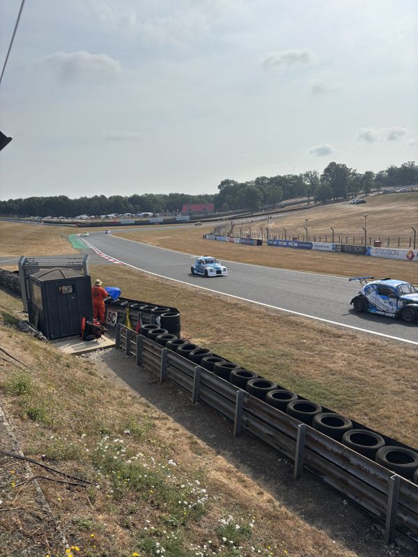 Fun Cup cars racing through a bend on the Brands Hatch Indy circuit