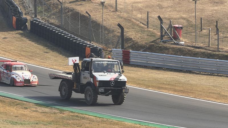 A recovery truck bringing a Fun Cup car back to the pits
